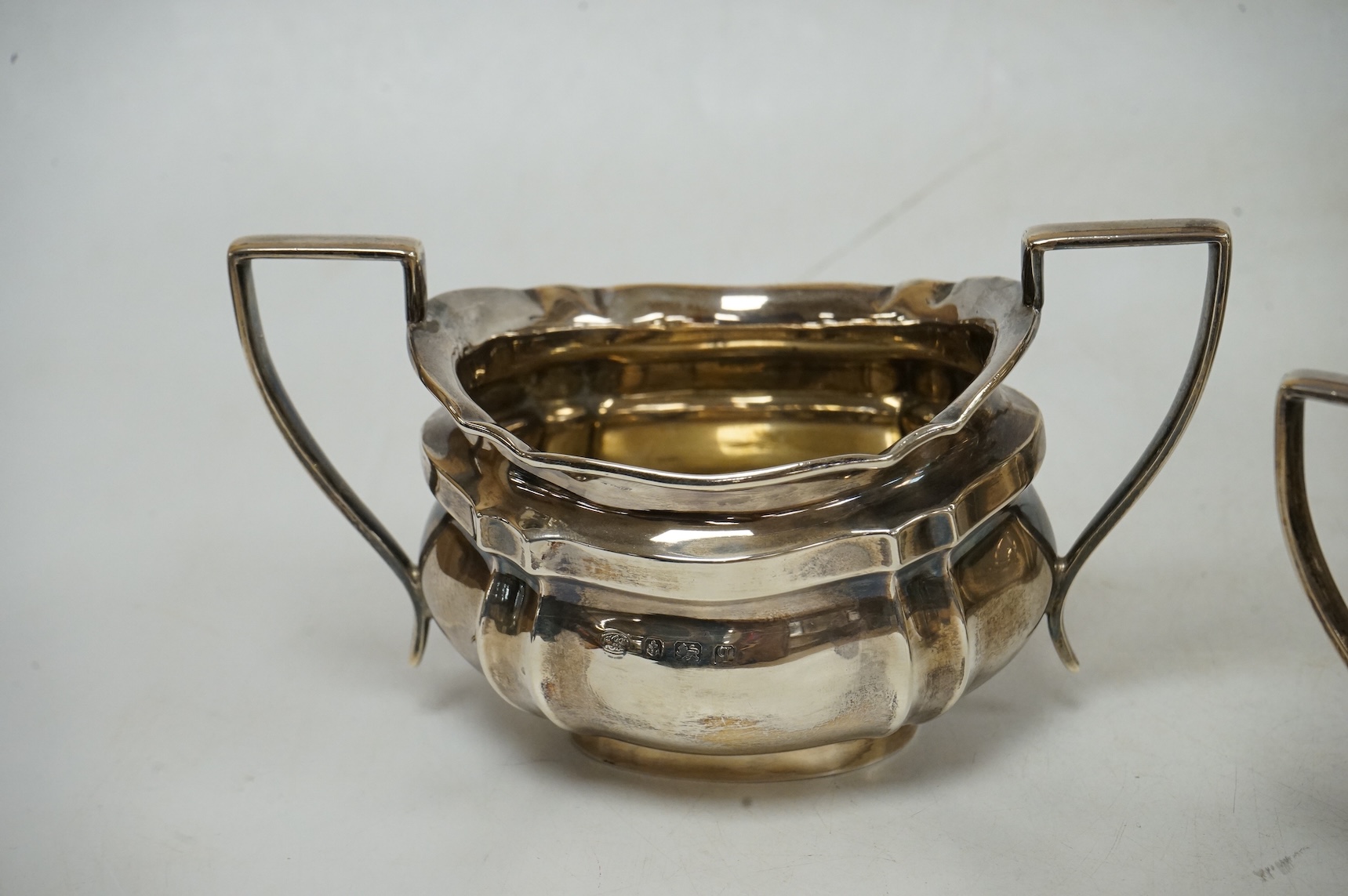 A George V silver oval three piece tea set, by Alexander Clark & Co Ltd, Birmingham, 1914 & 1916, gross weight 18.9oz.